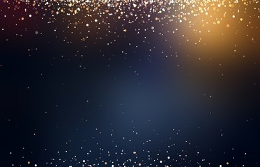 Golden glitter and flares on black blurred background.
