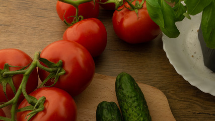 
Vegetables. Tomatoes and cucumbers with basil. Ready free entry space