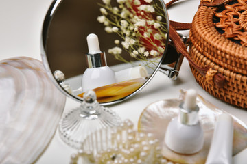 Dressing table with luxury cosmetic and skincare set, Cosmetic bottle containers with marine pearl extraction essence, Blank label for organic branding mock-up, Natural beauty product.