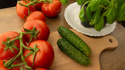 
Vegetables. Tomatoes and cucumbers with basil. Ready free entry space