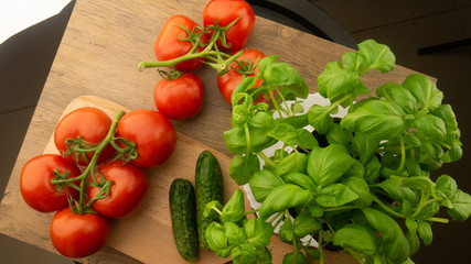 
Vegetables. Tomatoes and cucumbers with basil. Ready free entry space