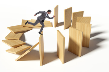 Businessman in domino effect concept