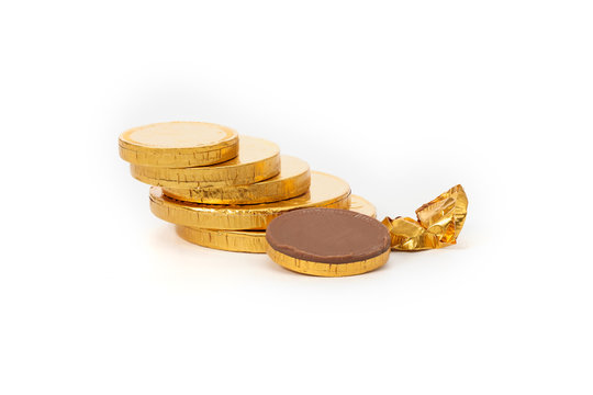 Close-up Of Chocolate Coins Over White Background