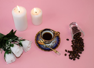 Obraz na płótnie Canvas .coffee, flowers, candles on a pink background as a symbol of home warmth and coziness, beauty and a wonderful morning breakfast