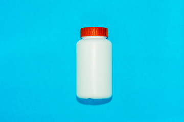 White plastic bottle isolated  blue background 