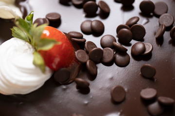 Naklejka na ściany i meble Chocolate chip topping with hot chocolate dripping cake stock photo