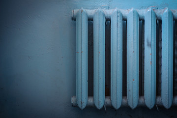 Old shabby radiator of blue color