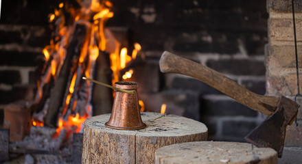 Brewing coffee in a Turk on an open fire .