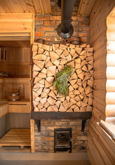 Interior of a wooden Russian sauna with traditional items for use.