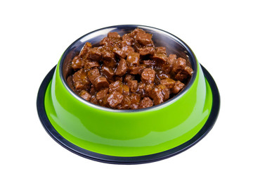 Canned food for cats or dogs in metal green bowl isolated on white background