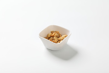 Delicious fat food, fried greaves pork in a bowl on white background.
