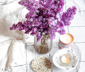 Cozy home interior with a bouquet of lilac.