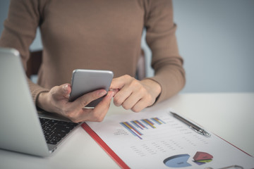 business woman working on white desk with laptop, smartphone at office look very busy. work from home concept