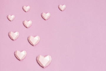 Volumetric paper hearts pink colored. Greeting card or invitation for wedding cards or Valentines Day. Pastel colors.