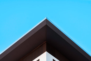 Abstract symmetry geometry minimal triangular high building on blue sky, creative concept...