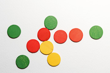 Colorful circles wooden on white background. Geometric shapes red, green, yellow colors, top view. Concept of geometry. Copy space. Children educational logical task. Flat lay.
