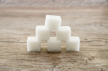 close up of sugar cubes on a wooden background
