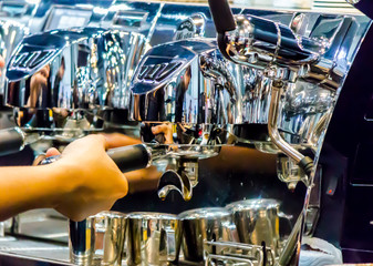 Espresso Machine pouring fresh coffee into cups at Local Coffee Shop..