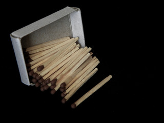 Still life with a matchbox scattered in the dark
