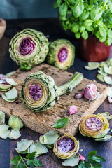 Fresh artichokes on dark rustic wooden background