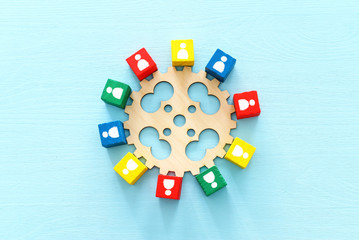 image of colorful blocks with people icons over wooden table ,human resources and management concept