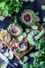Fresh artichokes on dark rustic wooden background