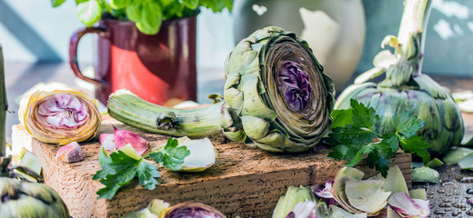 Fresh artichokes on dark rustic wooden background