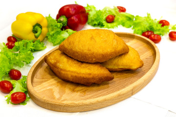 Pie, tart, pastry, baked gate with filling on a plate on the table, lunch, fast food
