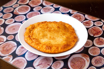 Pie, tart, pastry, baked gate with filling on a plate on the table, lunch, fast food
