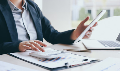 Accounting businessmen are calculating income-expenditure and analyzing real estate investment data, Dedicated to the progress and growth of the company, Financial and tax systems concept.