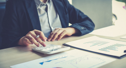 Accounting businessmen are calculating income-expenditure and analyzing real estate investment data, Dedicated to the progress and growth of the company, Financial and tax systems concept.