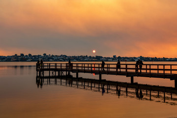 Fototapeta na wymiar Red sky bushfire sunset at Shelley Jetty
