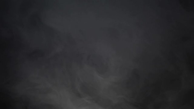 Abstract smoke cloud. Smoke in slow motion on black background. White smoke slowly floating through space against black background. Atmospheric smoke 4K Fog effect. VFX Element. Haze background. 
