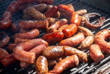 Grilled chorizo ​​sausages outdoors, celebrating plenty of protein meat and nutrition.