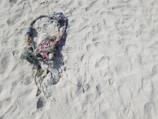 circle shaped garbage on the sand beach with some space on the right 
