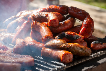 Grilled chorizo ​​sausages outdoors, celebrating plenty of protein meat and nutrition.