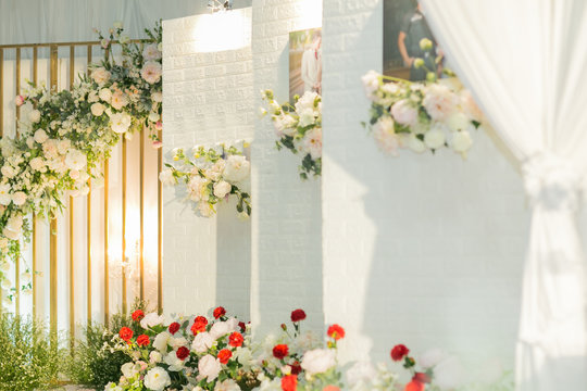 Blurred images of wedding ceremony at night,The white backdrop is decorated with beautiful flowers and leaves for the wedding of the couple.