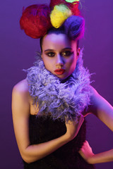 Fototapeta premium Portrait of a girl with a creative hairstyle in neon light (soft light)