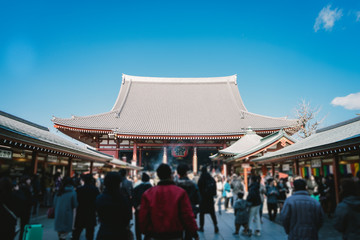 Fototapeta premium Blurry image Tourists pour in to pray at Sensoji or Asakusa Temple is temple Tokyo's largest Buddhist in the Asakusa area. People like to walk and pay a visit to both the temple and the outside.