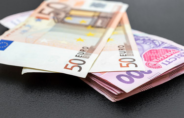 Ukrainian money with euro bills on black background. Exchange rate.