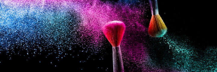 Two brushes with pink and blue make up powder impact to make a colorful cloud. - obrazy, fototapety, plakaty
