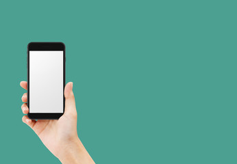 Hand holding black smartphone isolated on green background