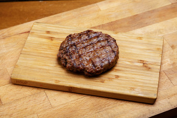 Meat cutlet for burger on a blackboard