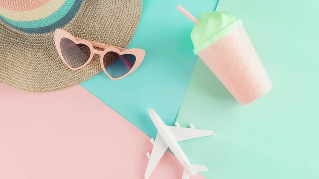 Women's accessories items on pastel colors background, Summer vacation concept, Stop motion
