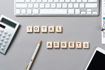 Total assets concept with letters on cubes
