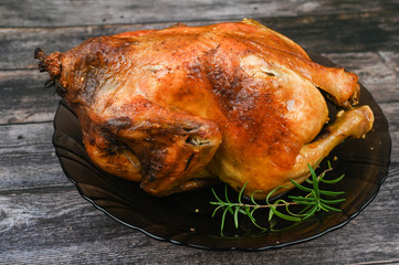 Baked chicken on wooden background