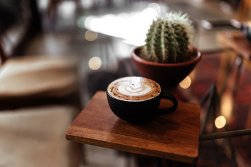 cup of coffee on table in cafe, vintage style copy space