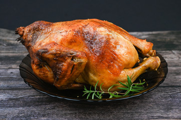 Baked chicken on wooden background