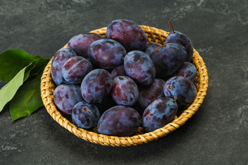 Ripe plum heap in the basket