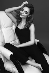 Fototapeta premium Gorgeous young woman dressed in black jumpsuit